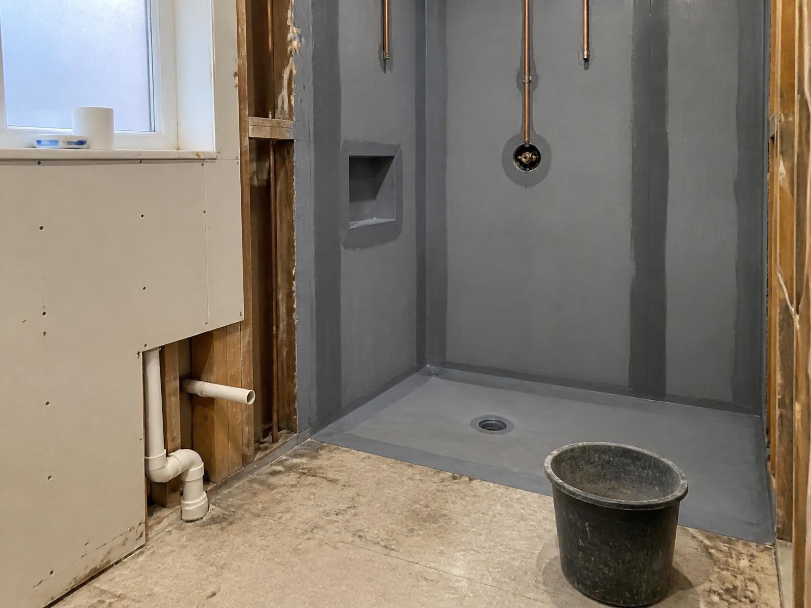 Shower area with tanking applied over backer board before tiling