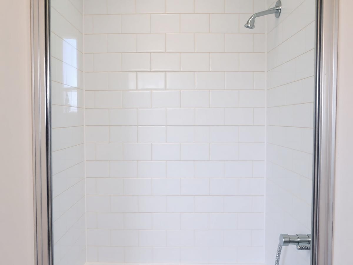 Tiled shower enclosure with chrome trim in Croydon